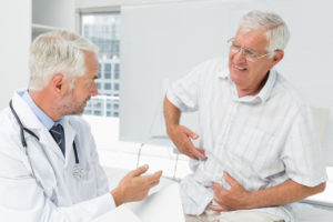 Male senior patient visiting a doctor at the medical office - GI Specialist