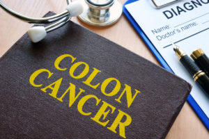 Book with title colon cancer and stethoscope.