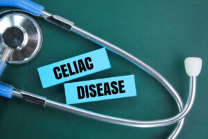 Stethoscope and colored paper with the word CELIAC DISEASE to explain the concept of disease and medicine.