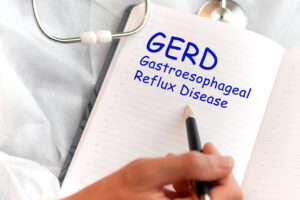 Doctor holding a card with text GERD, medical concept